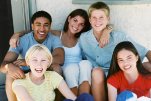 5 teenagers sitting together